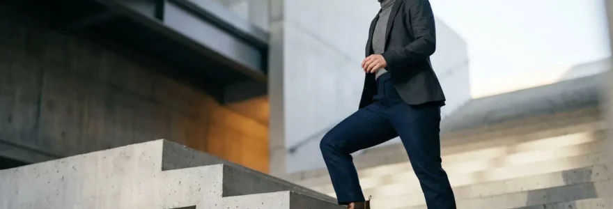 Professionnel confiant gravissant un escalier métaphorique vers une opportunité ambitieuse